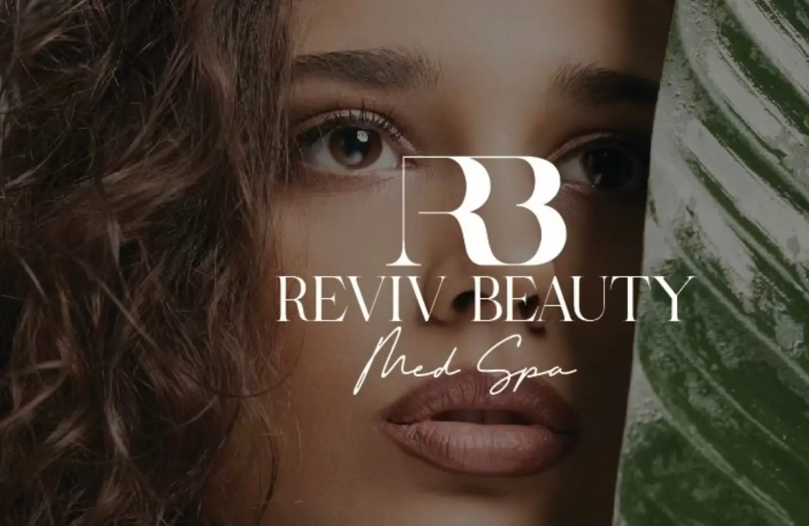 A serene close-up of a woman’s face partially framed by lush greenery, representing natural beauty and elegance, with the Reviv Beauty Med Spa logo prominently displayed.